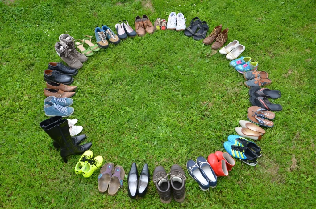 Pairs of shoes arranged in a circle on the grass