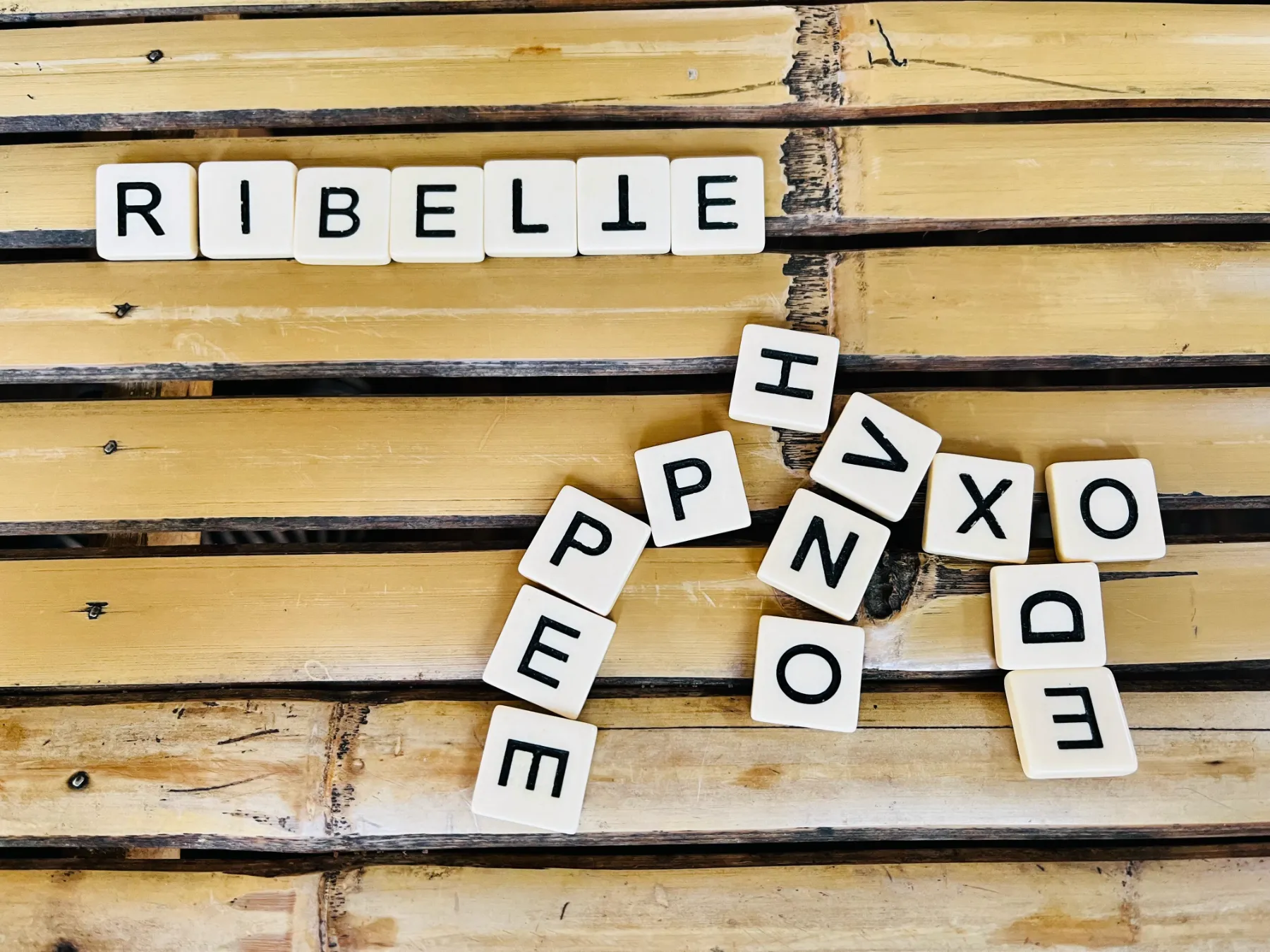 Scrabble pieces on a wooden table
