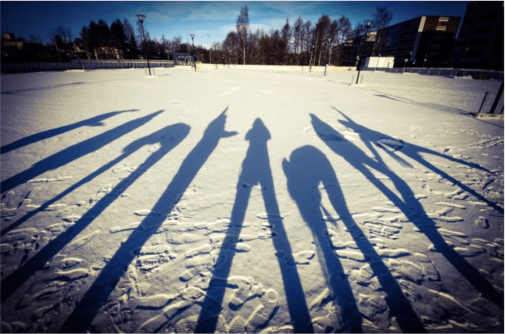People’s shadows on a snowy surface