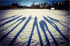 People’s shadows on a snowy surface