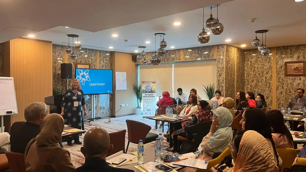 Dr. Laura Lorenz facilitating photovoice training in Dubai for doctors, researchers, and field workers from the Pakistani Institute for Living and Learning. Source: PVWW
